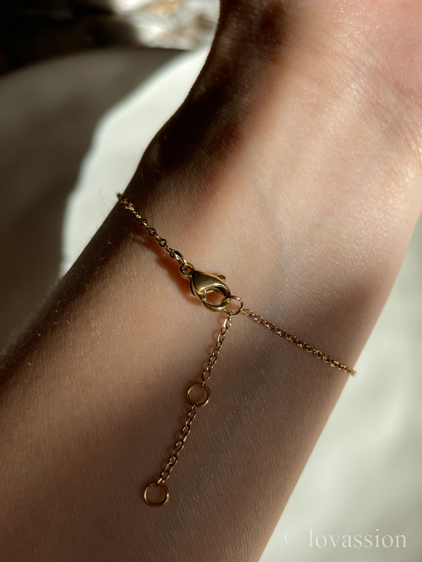 Crescent moon friendship bracelet on wrist
