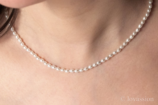 women wearing tiny rice pearl necklace