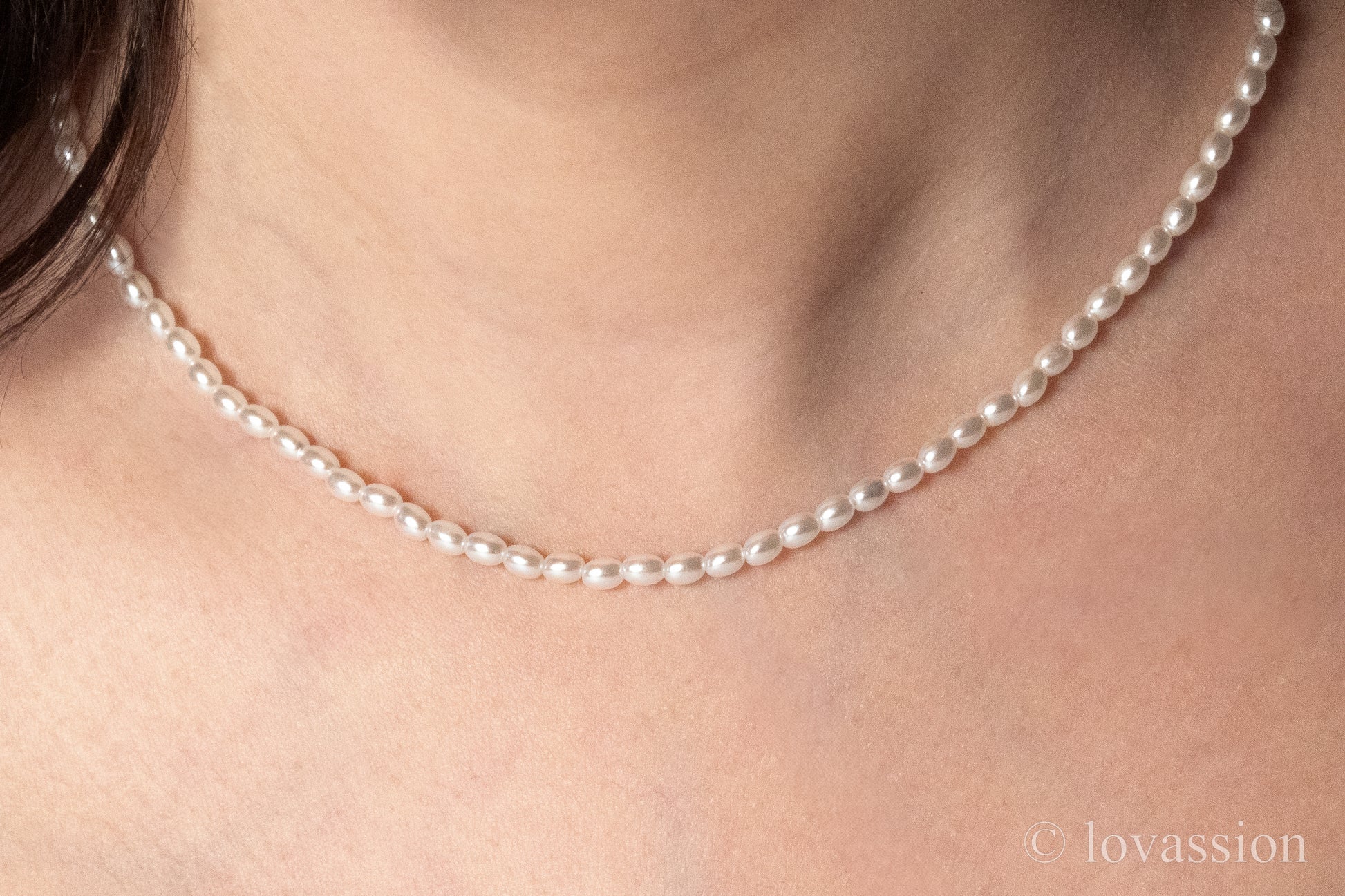 women wearing tiny rice pearl necklace