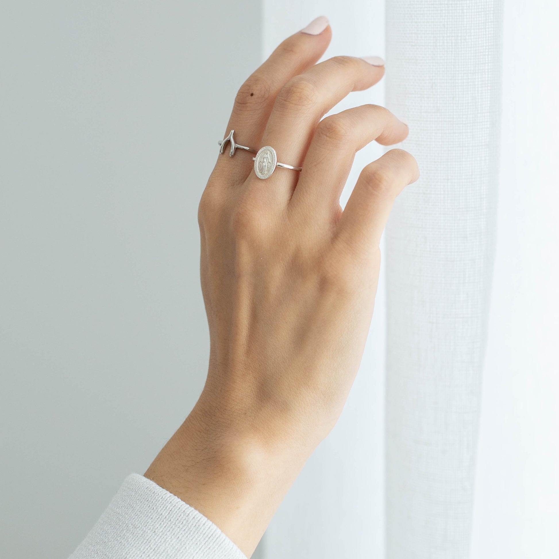 silver wishbone ring on hand