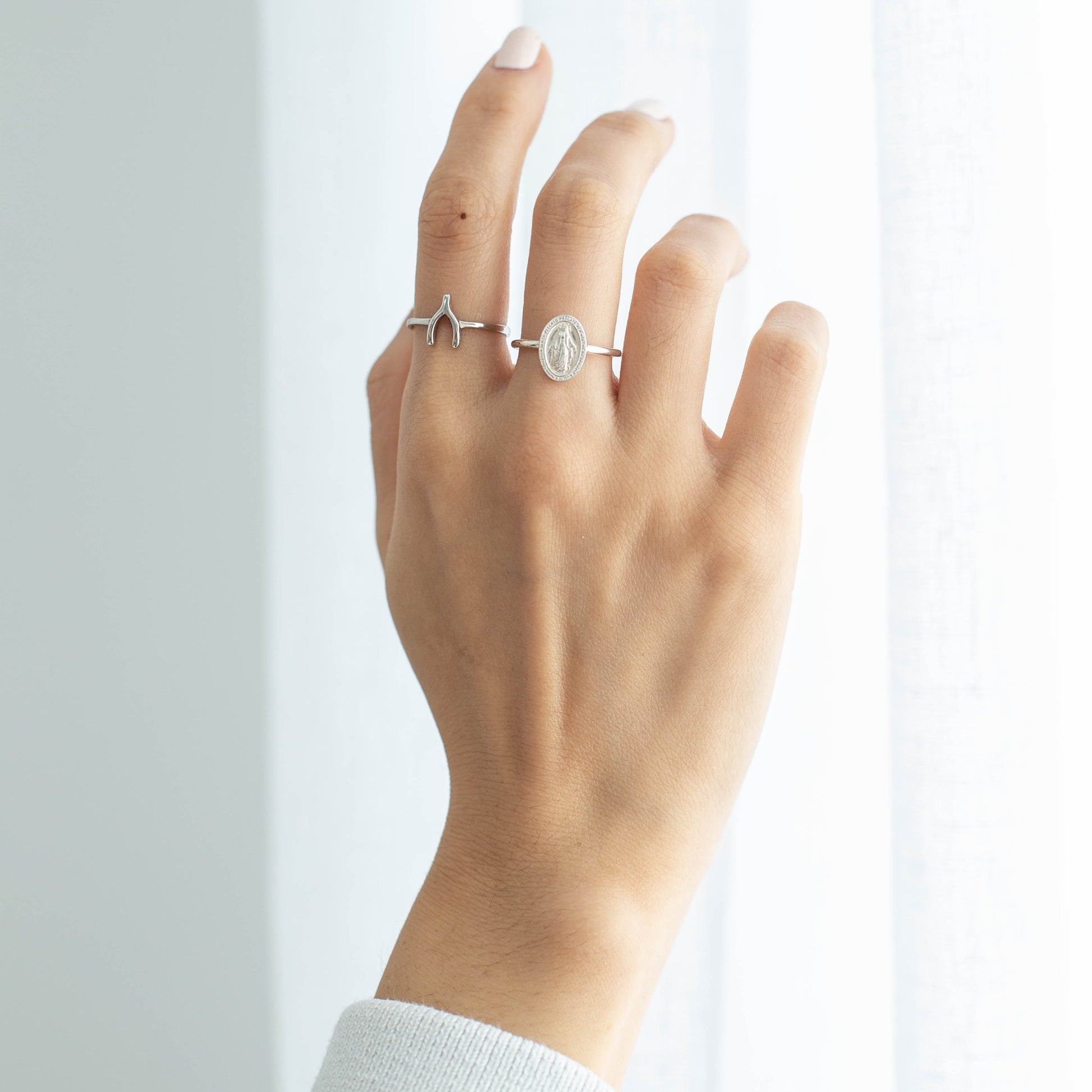 silver wishbone ring on hand