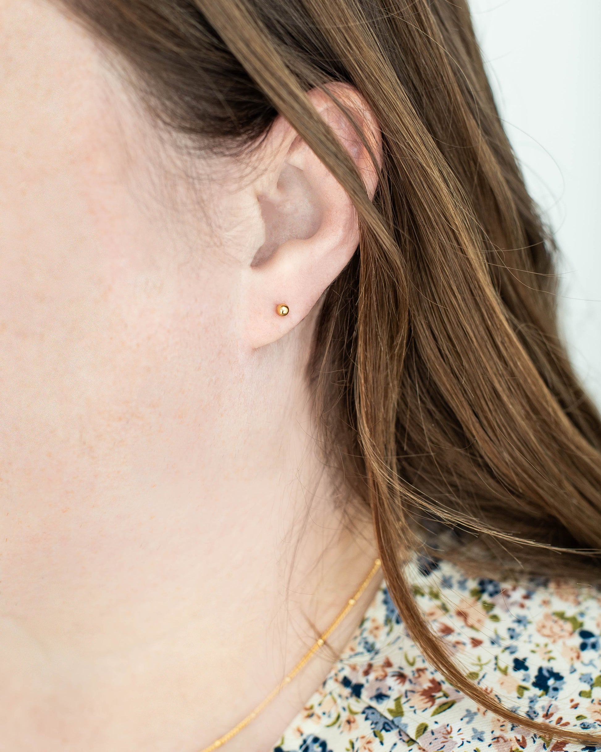 women wearing tiny ball studs